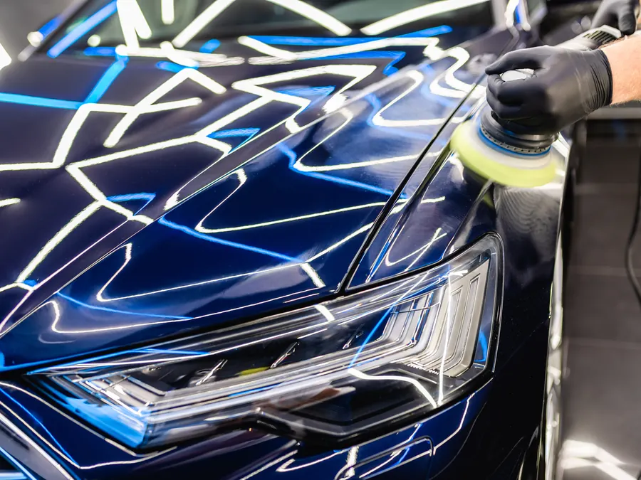 A detailer polishing a car.
