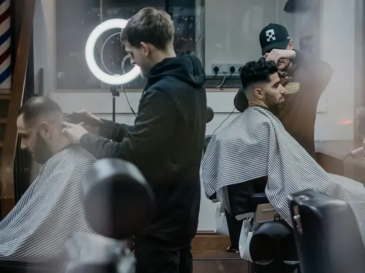 A barber at work in a barbershop.