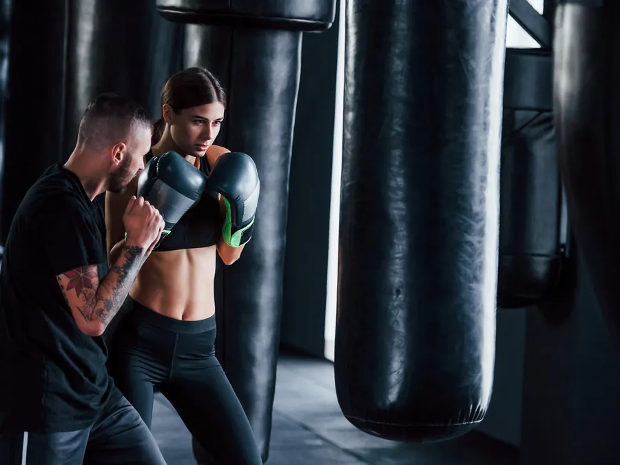 A boxing coach training a client.