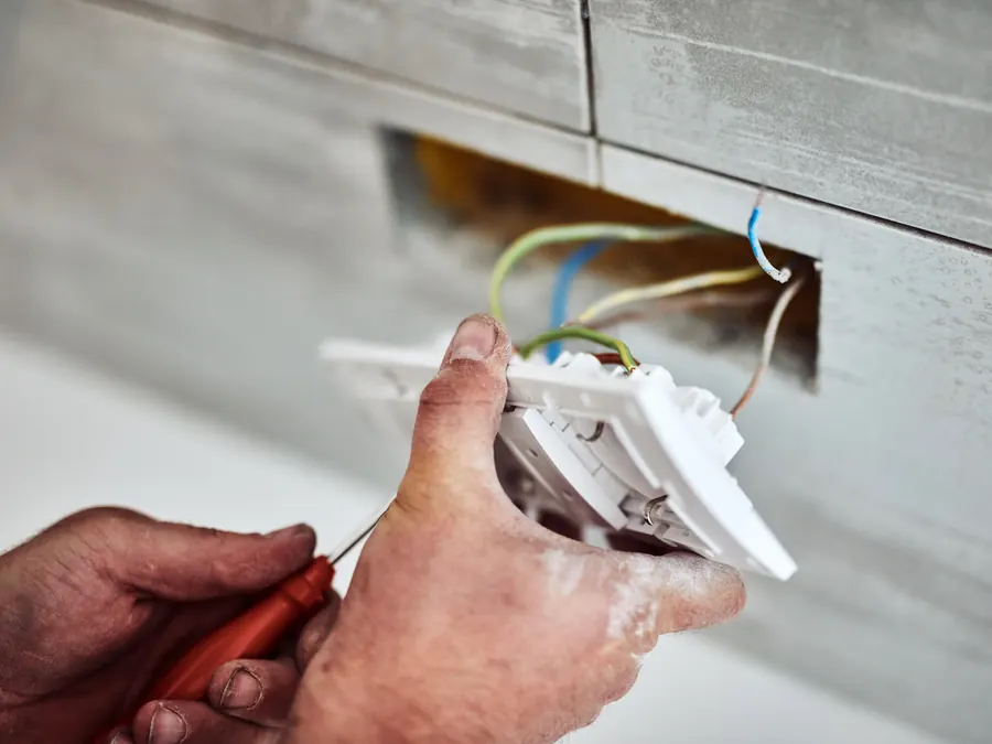An electrician wiring an outlet.