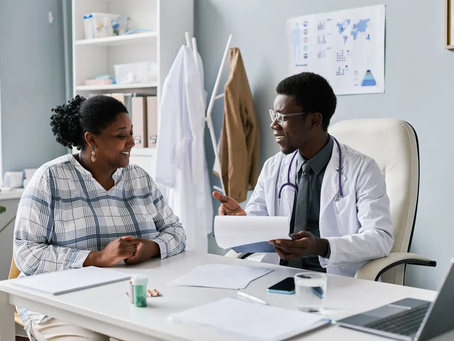 A doctor talking with a patient in a clinic.