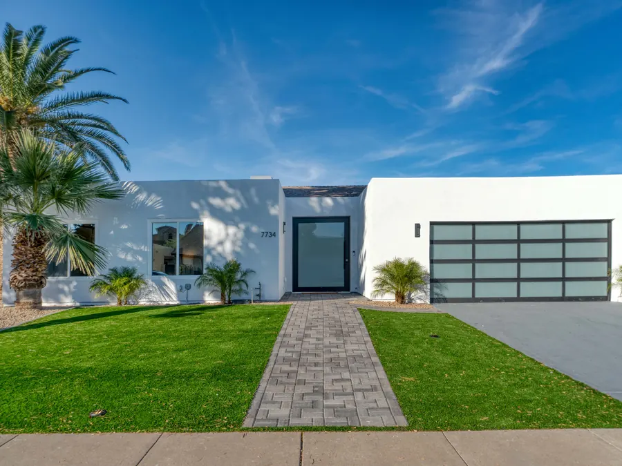 A modern home with a front yard.