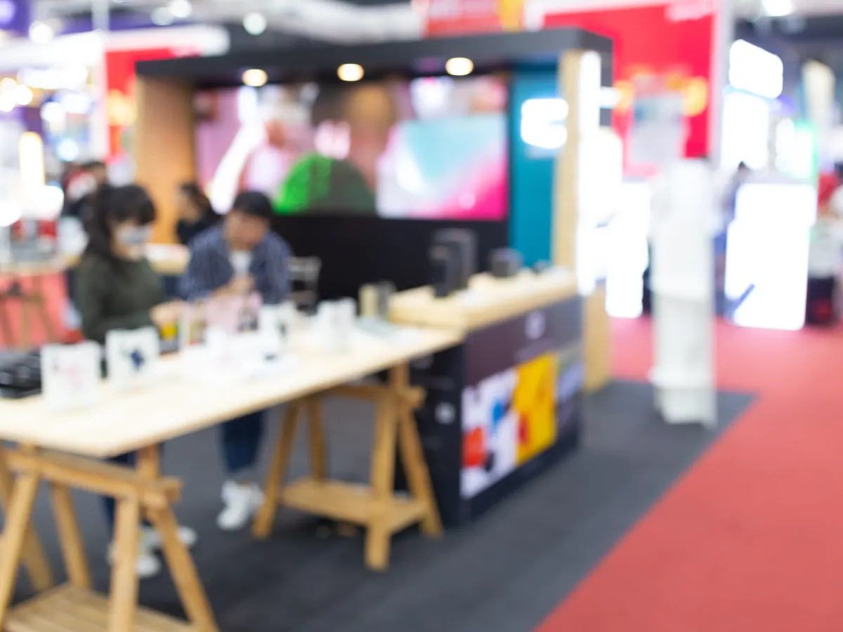 A branded booth at a busy trade show.