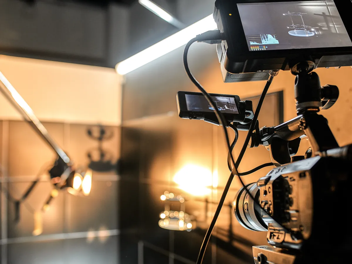 A cinema camera rig with monitors on a lit studio set.