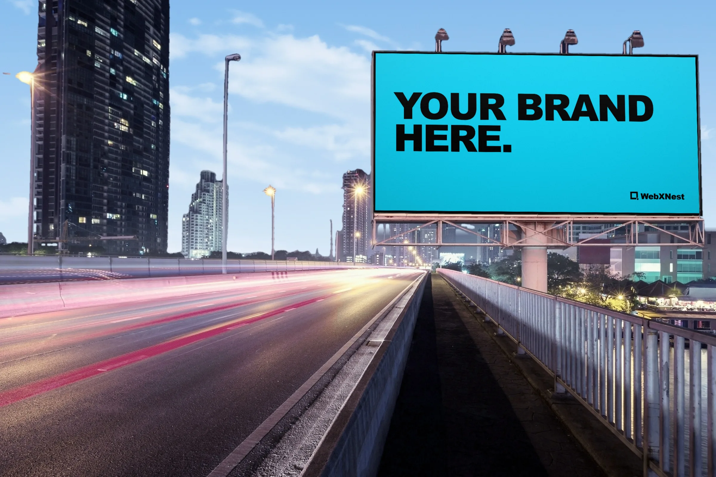 The same billboard over the highway on a sunny afternoon, its screen reading &ldquo;Your brand here.&rdquo;
