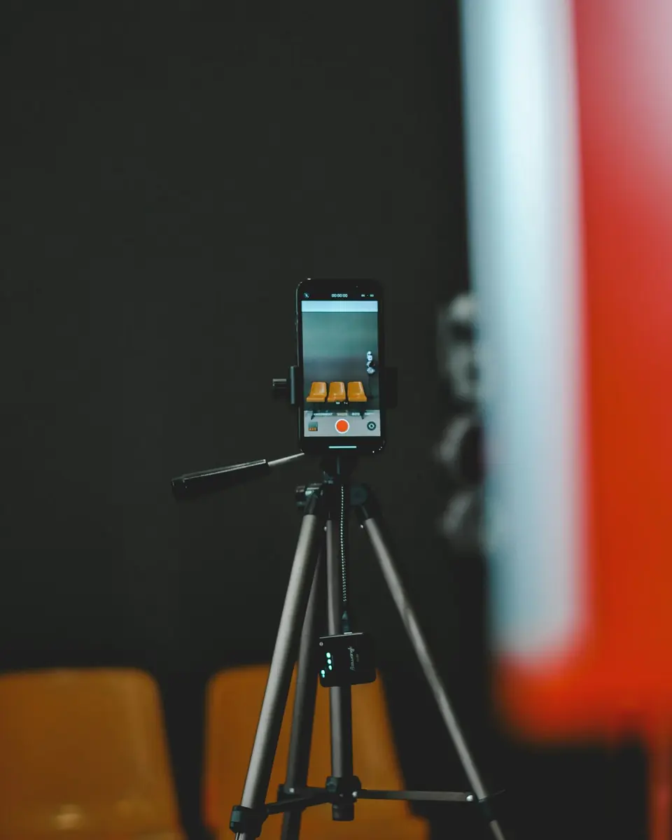 A phone on a tripod, recording a short video.
