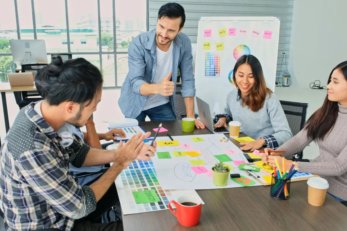 A young team planning a campaign with sticky notes around a table.
